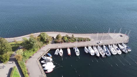 langelinie marina with yachts parked in it over a serene baltic sea on a beautiful bright day in copenhagen, aerial view