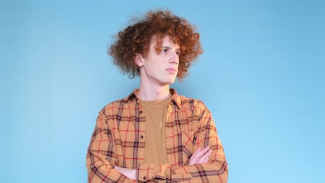 promotional video of a young guy with an interesting hairstyle on a blue background promotional video of a young guy with an interesting hairstyle on a blue background video shooting in the studio a calm focused young man