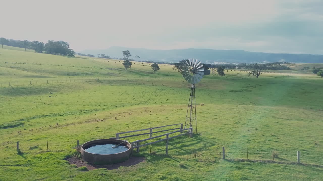 Rural Landscape - Small Wind Turbine On Green Field On A Sunny Day Near Berry, New South Wales - aerial drone shot