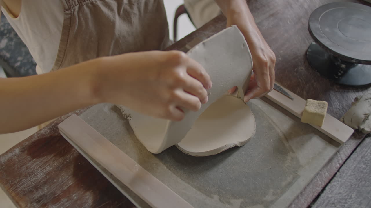 Asian Woman Working with Clay at Pottery Masterclass