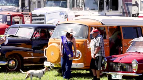 people interacting at a vintage car show