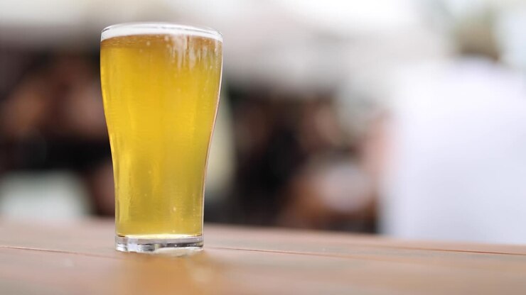 A full glass of beer gradually being emptied