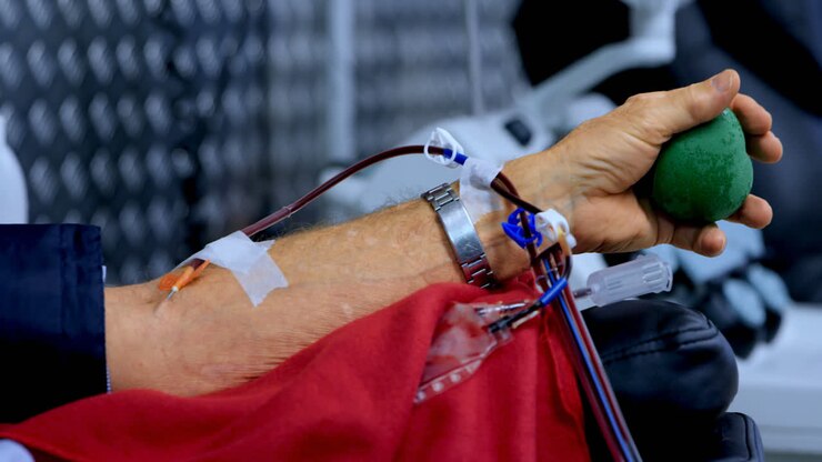 Senior man donating blood in blood bank 4k