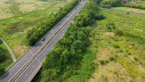 smooth towards aerial movement near of the hambrook marshes a2 roadway with heavy traffic, canterbury, united kingdom