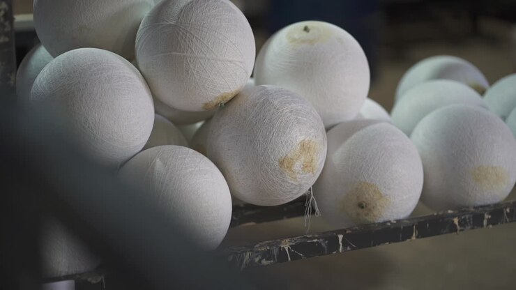 Semi-finished and formed into fabric handballs are waiting on the loading bay for the next steps in the factory