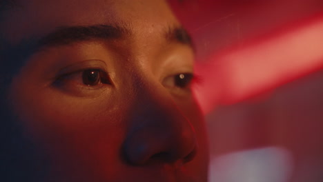 close-up of a person's face in red light