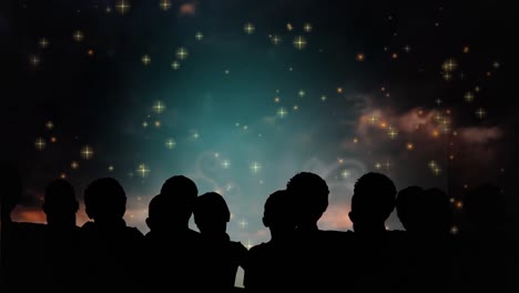 animación de siluetas de personas y estrellas sobre fuegos artificiales