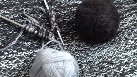 balls of grey and black wool yarn, needlework