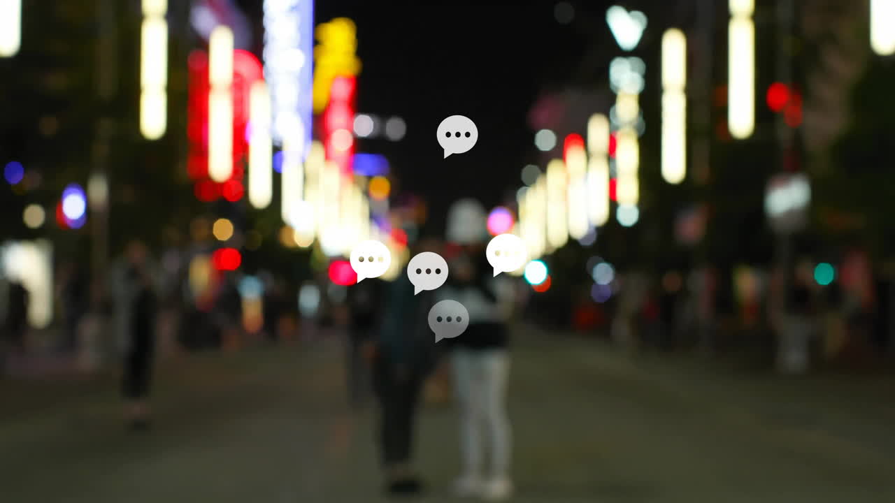 Speech bubbles animation over people walking on brightly lit city street at night