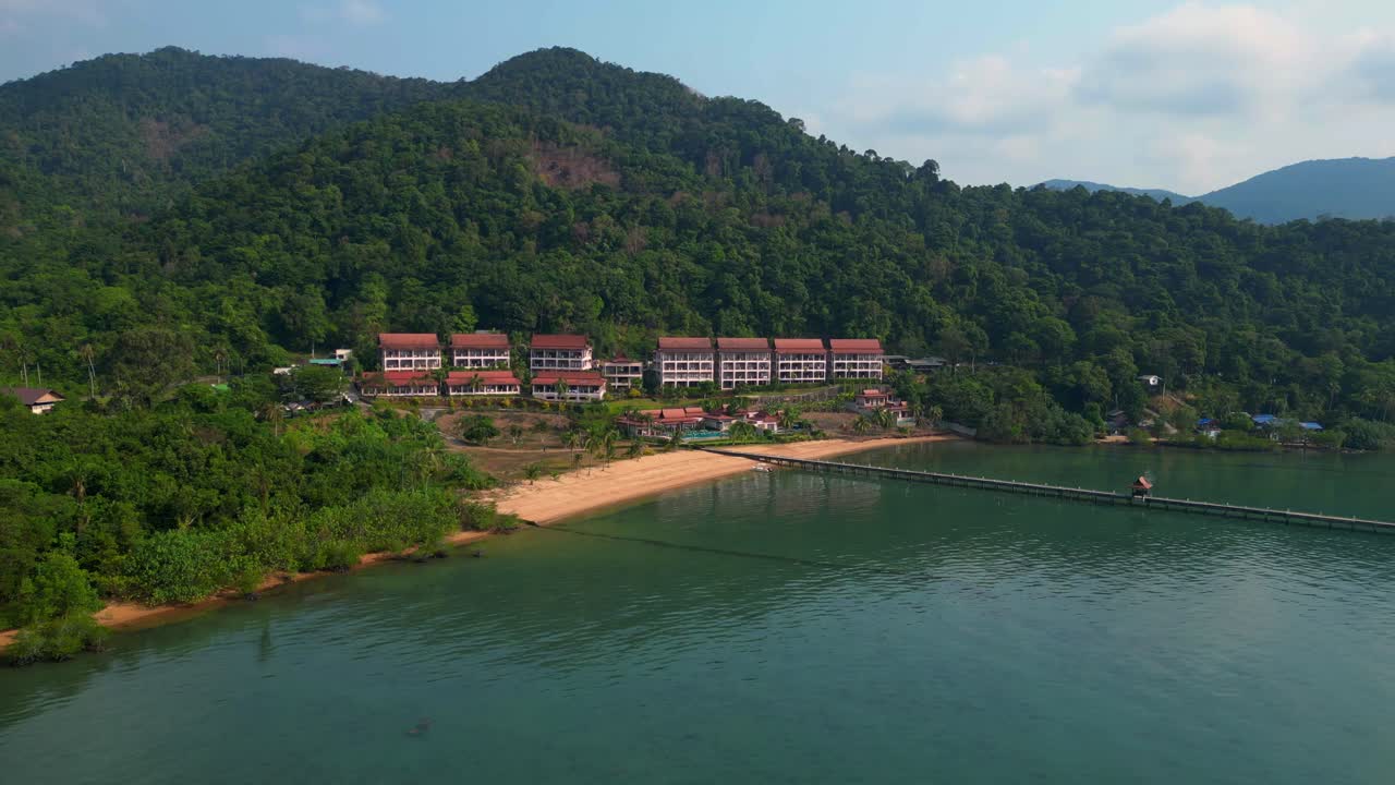 long pier reaching a beautiful resort by the sea in a tropical island koh chang. Breathtaking aerial view flight panorama overview drone