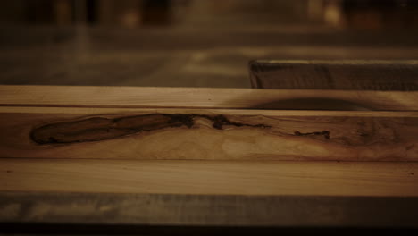 unknown guy cutting plank indoors. guy working with saw machine in studio