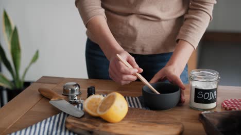 Unrecognizable-person-adding-soap-to-the-bowl-with-DIY-cleaning-product.