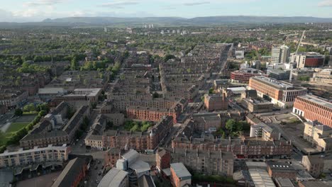 aerial orbit around byres road in glasgow's west end flats and glasgow university in sunny evening, scotland, uk