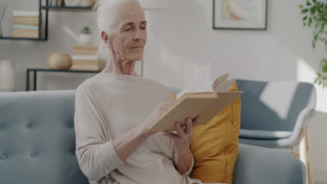 elderly woman reading a book at home