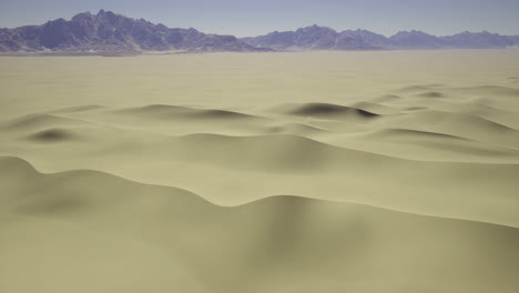 expansive desert landscape with gentle sand dunes and distant mountains
