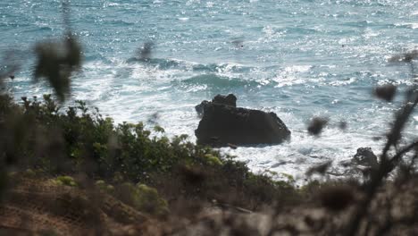 waves crashing on rocks at the coast