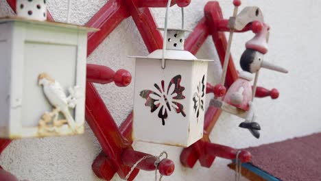 white lantern with butterfly design hanging on a red wooden rack