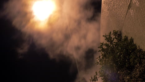 street lantern and condensing smoke spreading outside at night