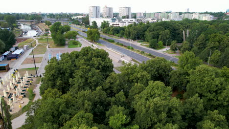 daytime traffic on wioslarska highway in warsaw by vistula river bank - aerial view in summer