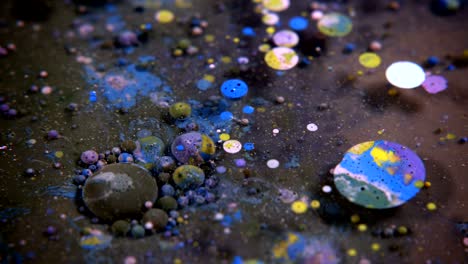 abstract colorful acrylic and food paint bubbles on water