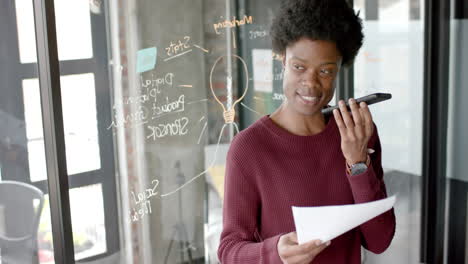 Happy-african-american-casual-businessman-talking-on-smartphone-at-home-office,-slow-motion