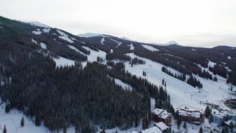 Toma-Aérea-De-Pistas-De-Esquí-En-Una-Montaña-Con-Esquiadores-Y-Snowboarders