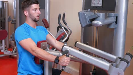 man using weights machine in gym