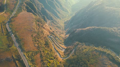 top down cinematic view of mountain tropical rainforest road, serra do rio do rastro and the mountains of santa catarina at sunrise