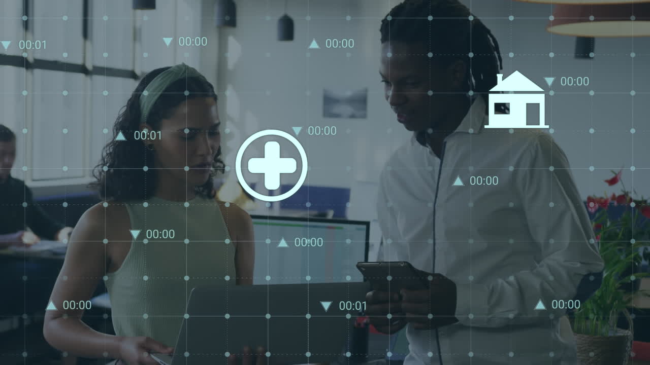 Animation of digital icons and data processing over diverse man and woman discussing at office