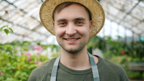 smiling gardener in greenhouse
