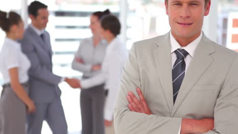 Panning-upwards-camera-showing-a-smiling-businessman