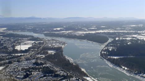 panoramic view of fraser river during winter in british columbia, canada. aerial wide shot