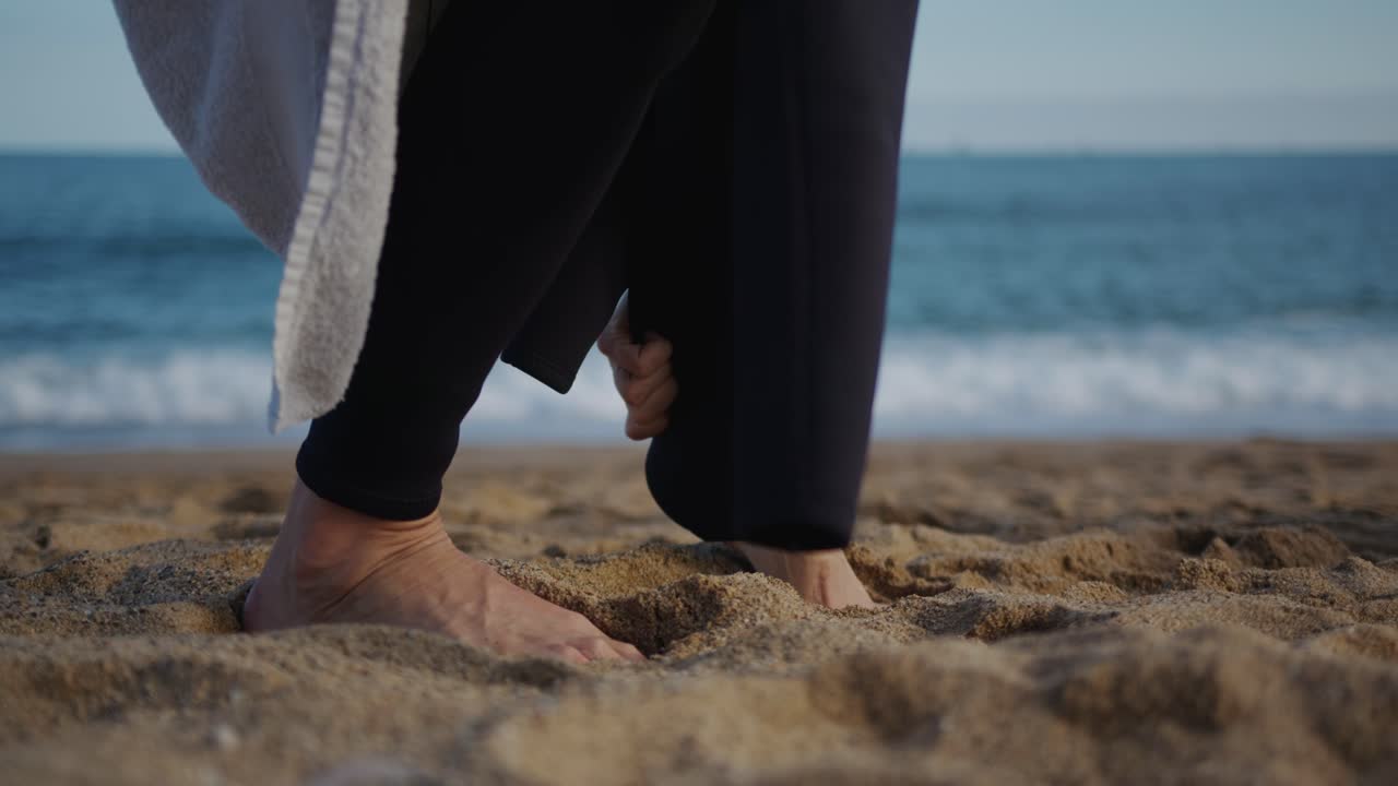 Surfer man walking to the beach at sunset preparing for surfing training and search for waves in Barcelona, spain, water, ocean exercise in sea with board, athletic male holiday or travel in vacation