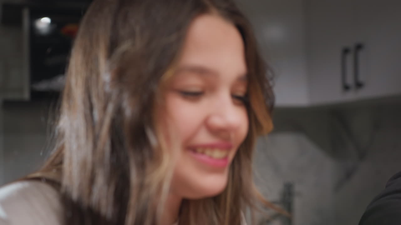 Portræt af venner på picnic i køkkenet, der snakker og griner, varmt og ærligt øjeblik med smil i nærbillede, naturligt dagslys i ansigtet, afslappet samtale, afslappede omgivelser og venlig stemning