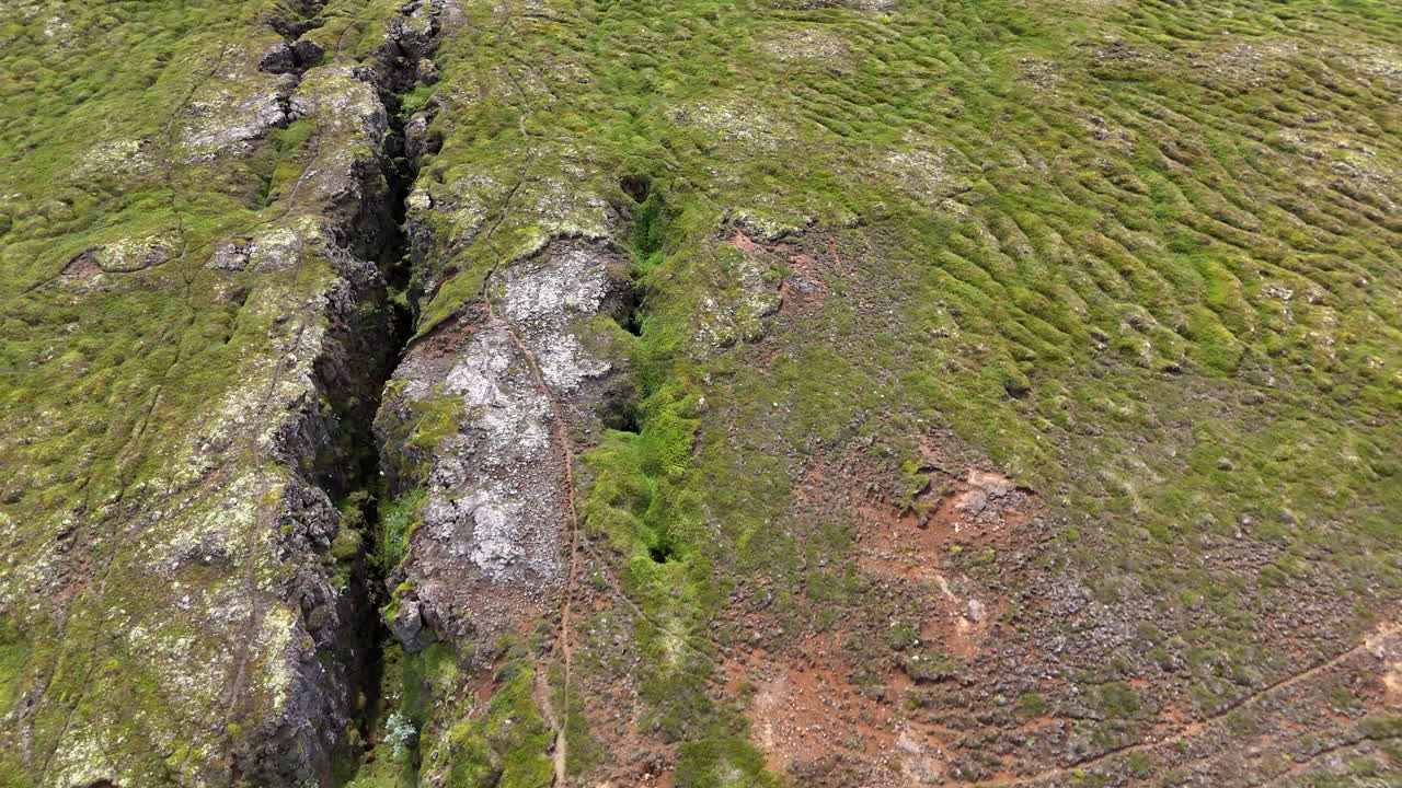 Drone view of northern Norðurland continental rift with visible tectonic plates, cracks in earth, and rugged Icelandic terrain