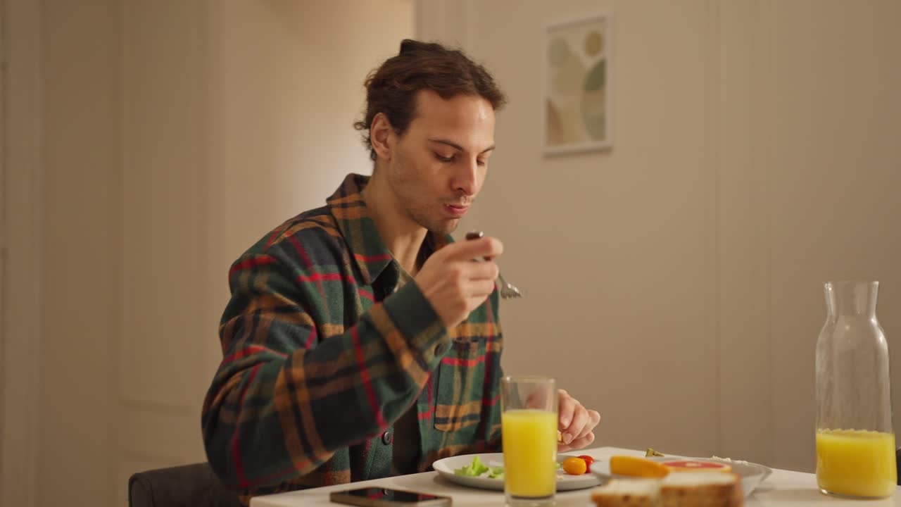 Man eating breakfast at a table