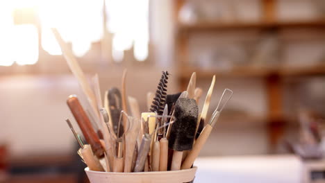 box with pottery tools on desk in pottery studio