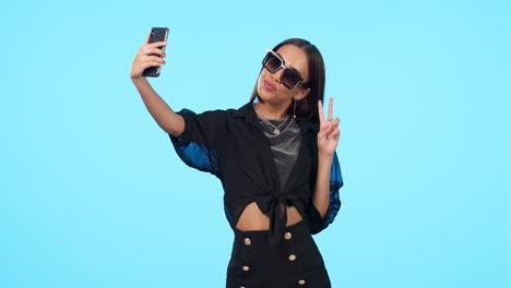 Selfie,-sunglasses-and-woman-with-peace-sign