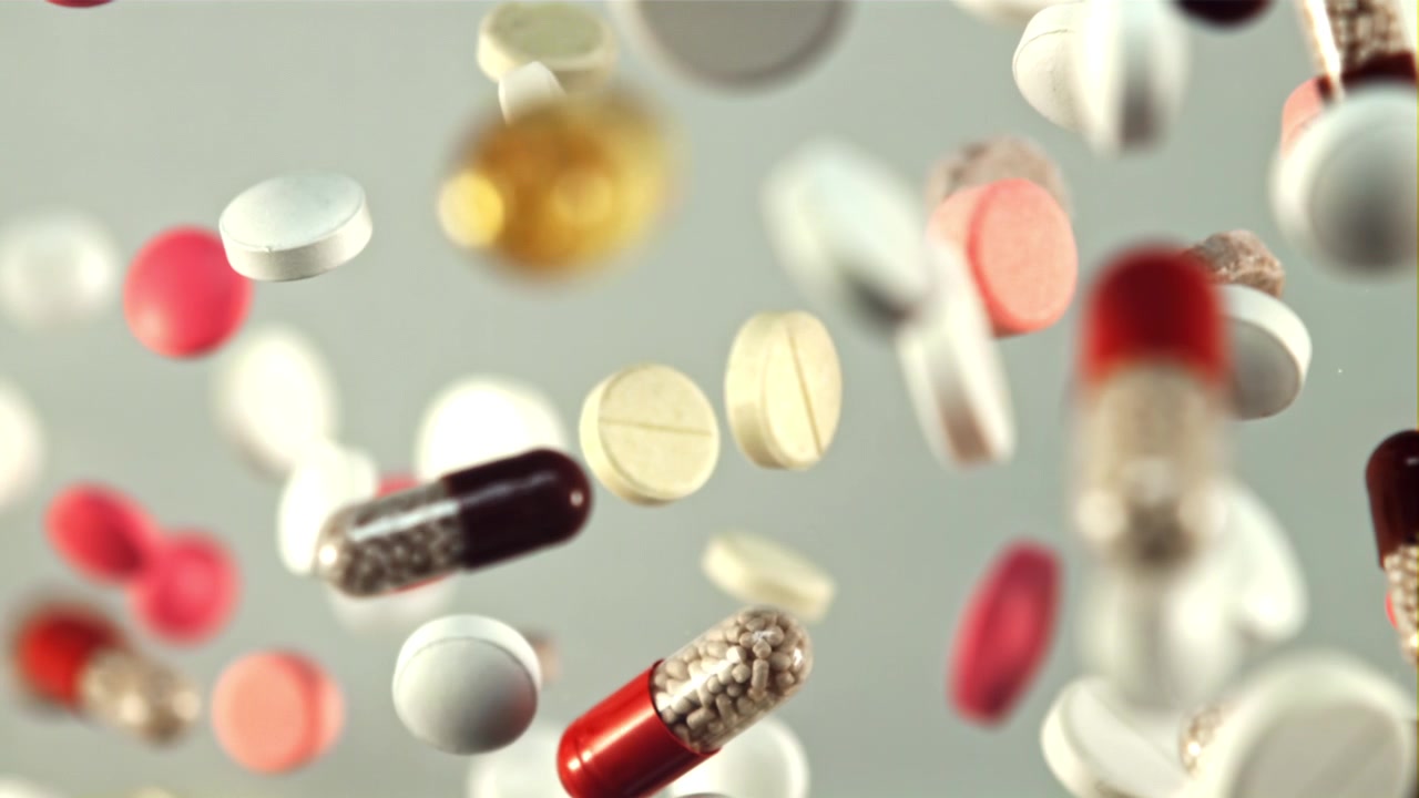 Slow Motion Shot of Assorted Pharmaceutical Pills Falling