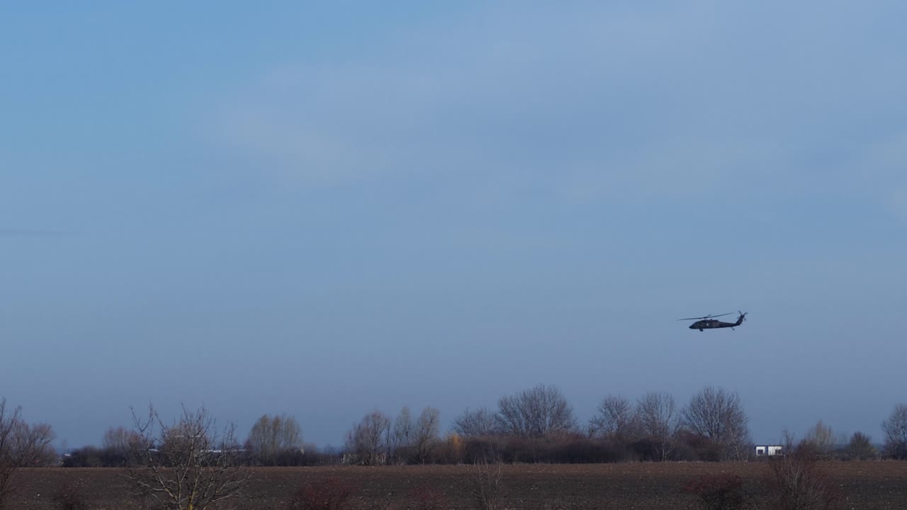 Side View Military Helicopter Moving Slowly Before Landing