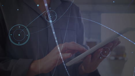 animation of network of connections over caucasian female worker using tablet