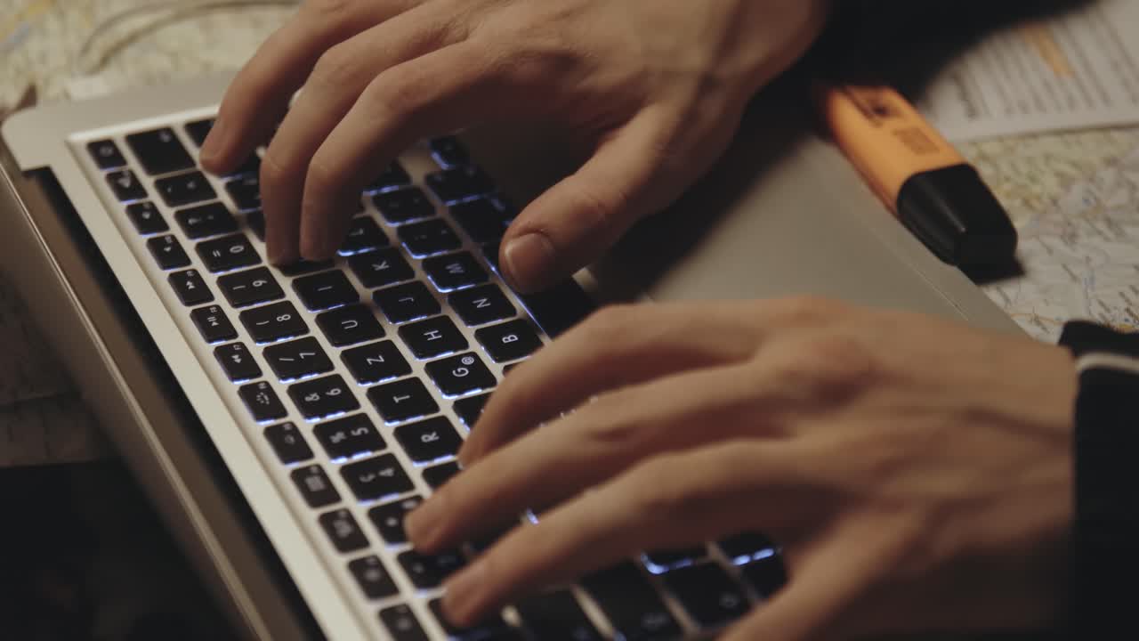 working on notebook near recording finger slow motion