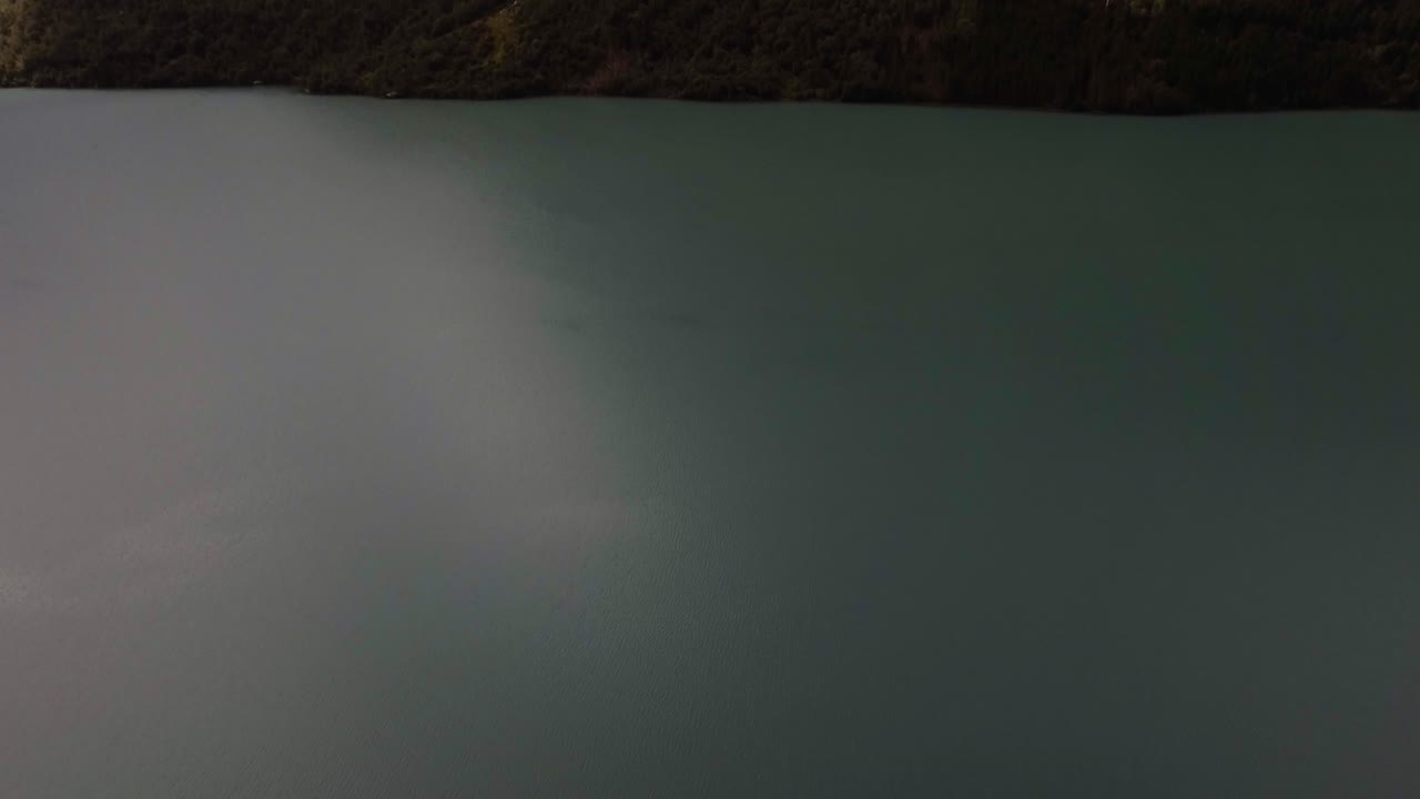 Aerial of a lake surrouded by mountains in Norway