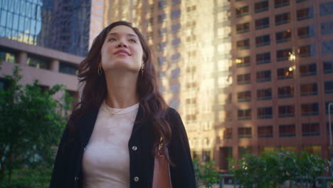 Attractive-woman-looking-whirling-closeup.-Happy-asian-girl-exploring-megapolis