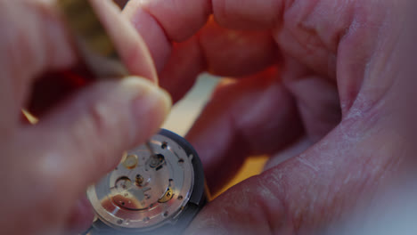 close-up of horologist hands repairing a watch