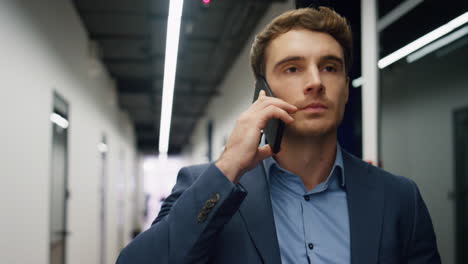 closeup businessman answering call leaving conference room. serious man lawyer