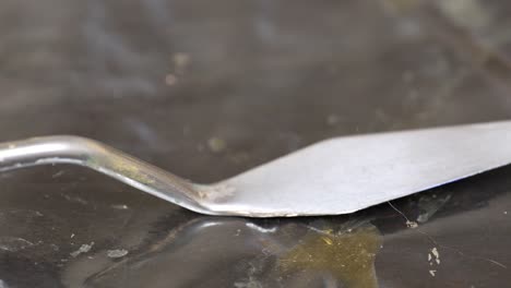 detailed close up of palette knife with worn wooden handle