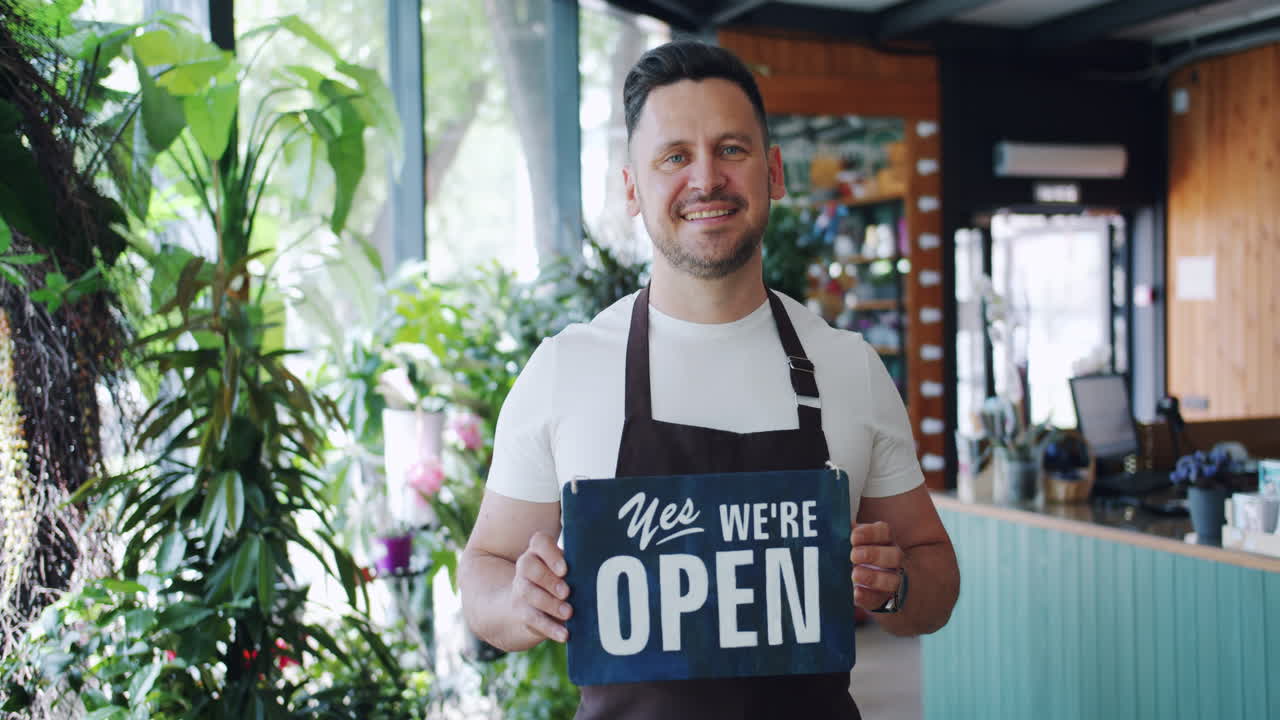 Florist Store Owner Holding Open Sign