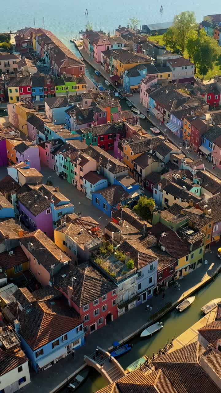 Aerial drone view of the colourful houses of Burano Island, Italy. Vertical