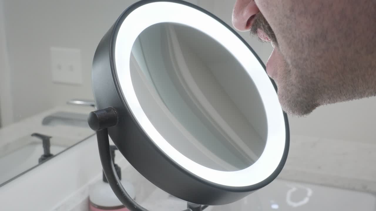 Side angled view of using a ring lit mirror